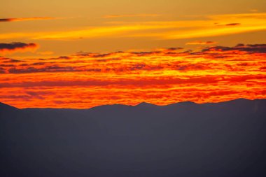Red clouds like a lava. Beautiful fiery sunset with red clouds
