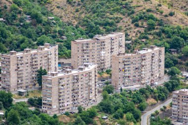 High-rise buildings of the city on the mountains. City in nature. Beautiful nature and city