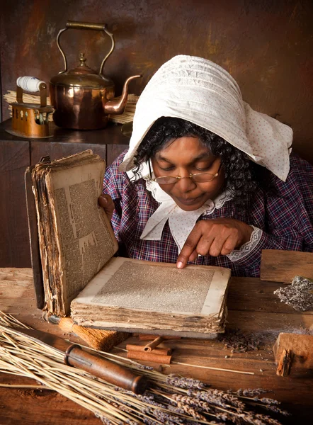 Vintage herb woman reading recipe — Stock Photo, Image