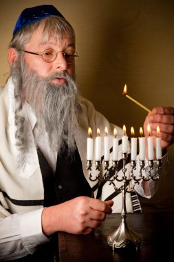 Lighting the menorah clipart