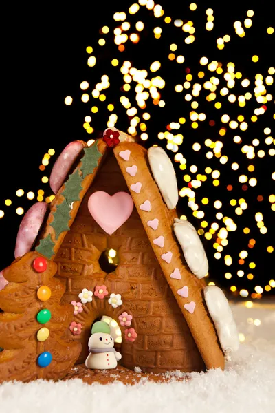 Christmas lights and gingerbread house — Stock Photo, Image