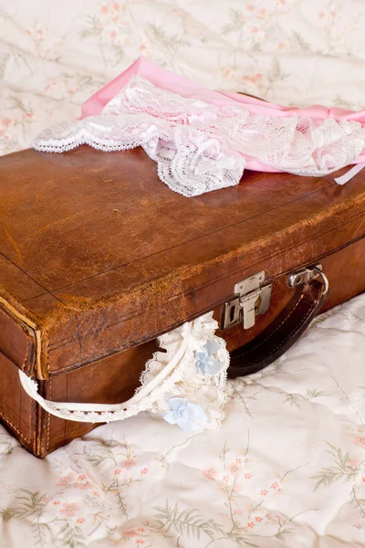 Grungy suitcase and lace lingerie — Stock Photo, Image