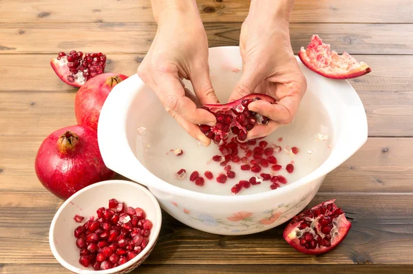 Pomegranate seeds in water — Stock Photo, Image