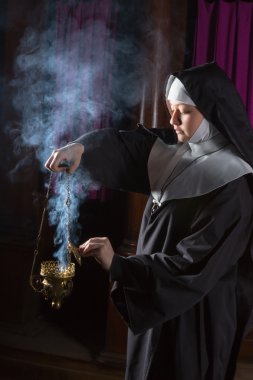 Nun preparing incense for mass clipart