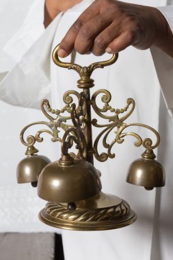 Consecration bells during holy mass clipart