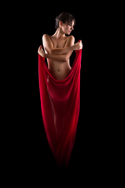 Artistic nude image of a woman wearing a red sheer fabric like a phoenix