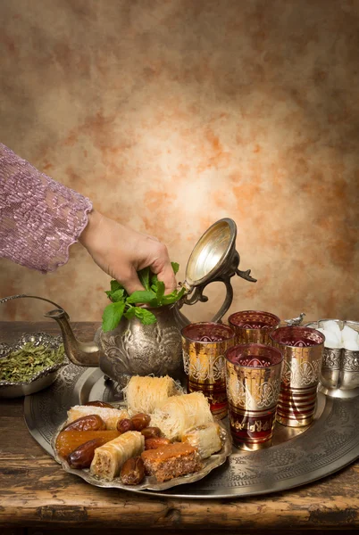 Adding mint to Moroccan tea — Stock Photo, Image