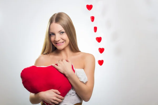 Young happy smiling woman with heart symbol — Stock Photo, Image