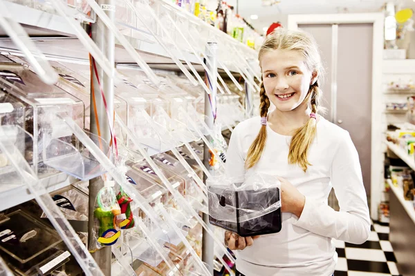 Chica joven en la tienda de dulces, la elección de dulces — Foto de Stock