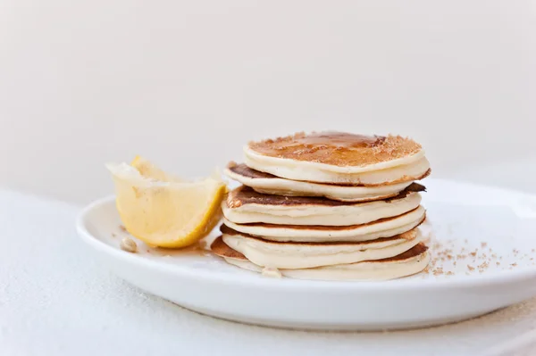 Stack of mini pancakes, with squeezed lemon — Stock Photo, Image