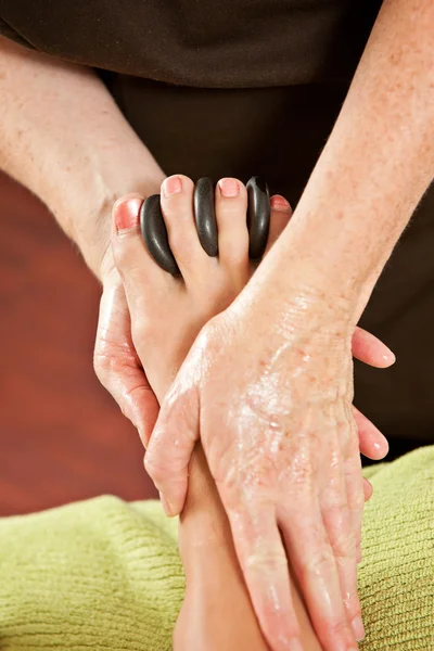 Foot massage with hot rocks — Stock Photo, Image
