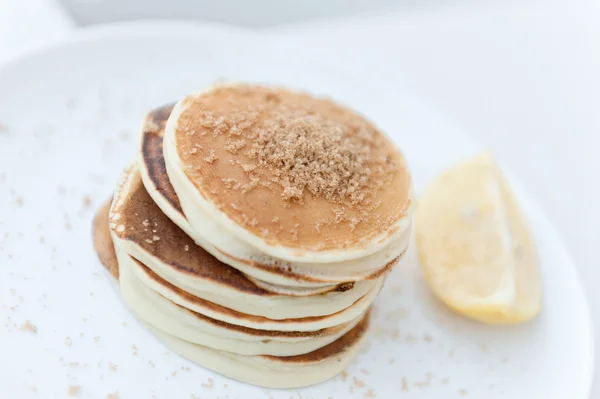 Top view pancakes with brown sugar and lemon — Stock Photo, Image