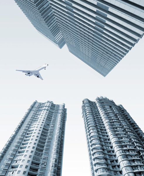 Airplane over the city High-rise buildings.