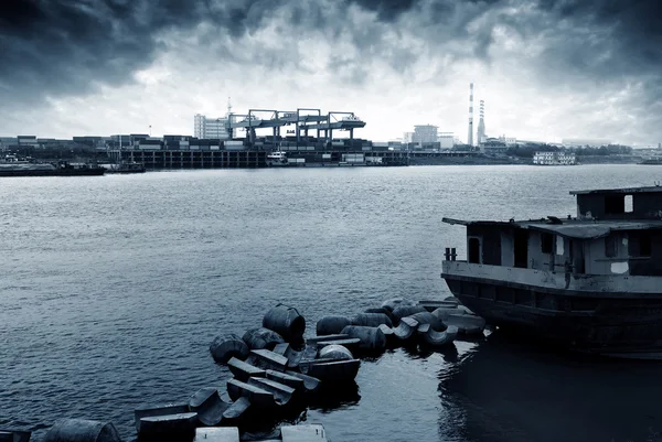 Container stacks and ship under crane bridge — Stock Photo, Image