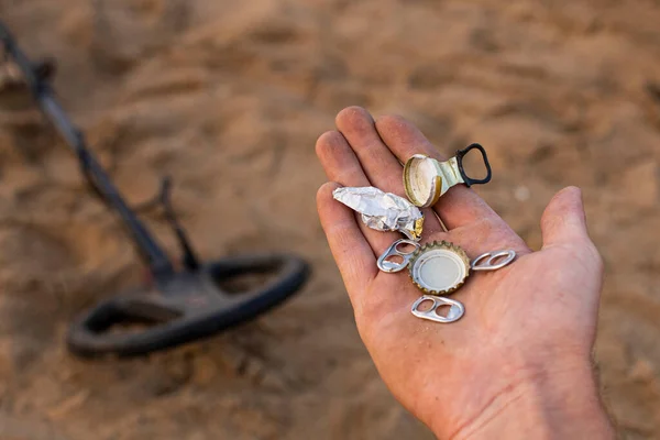 trash found on the beach with a metal detector, the problem of human pollution on the planet