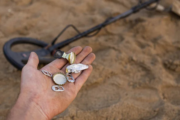 trash found on the beach with a metal detector, the problem of human pollution on the planet