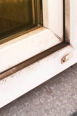 Uzun bir kıştan sonra kirli plastik pencereler, şehir merkezindeki bir toprak tortuları. ön ve arka plan bokeh etkisi ile bulanıklaştırıldı