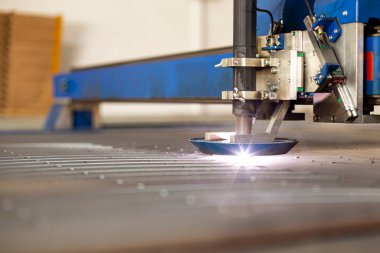 Bir CNC makinesinde, ülkenin merkezindeki büyük bir makine-alet fabrikasında yakın çekim lazer kesimi.