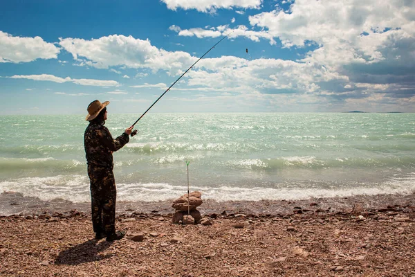 fisherman fishing on the ocean with a rod and bait for big fish