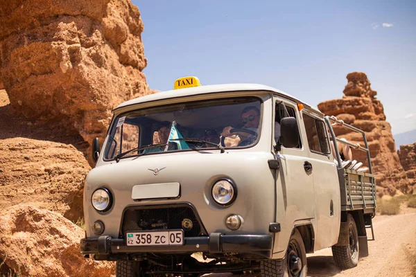 July 6, 2022, kazakhstan, charyn canyon. off-road taxi 4x4 bringing people from the river valley to the plateau