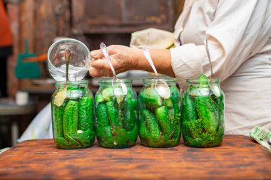 grandmother preparing stocks of pickles to avoid hunger, the background is blurred