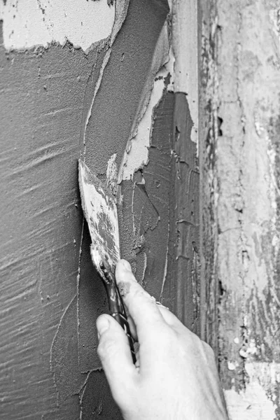 close up hand worker plastering cement on wall for building house