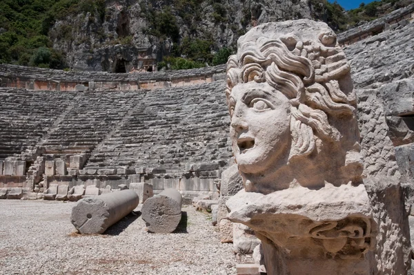 Stone mask and ancient amphitheater, Myra (Turkey) — Stock Photo, Image