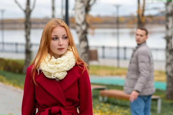 beautiful woman walks in the park, the young man looks back at her