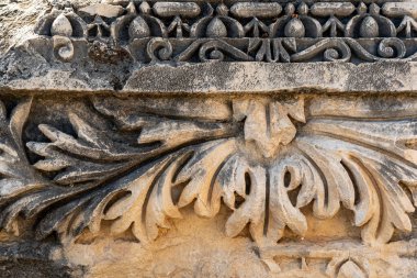 ancient stone-cut floral ornament on the ruins of a building in the ancient city of Myra, Turkey