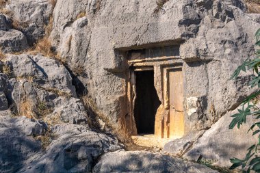 entrance to an ancient stone tomb carved into the rock in Myra Lycian (now Demre, Turkey)