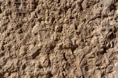 texture of a natural roughly cut stone of some ancient building