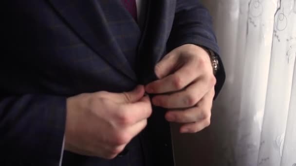 A man buttons up a beautiful jacket — Stock Video