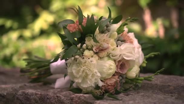 Wedding bouquet lies on the stones — Video