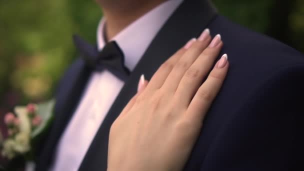 The bride strokes the grooms hand — стоковое видео