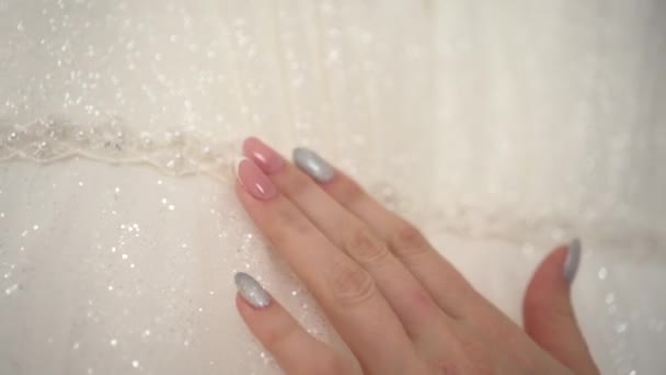 The bride strokes the wedding dress with her hand — Wideo stockowe