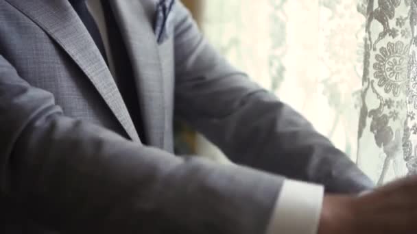 Man buttons on gray jacket — стоковое видео