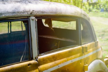 Vintage rusty passenger car in the park