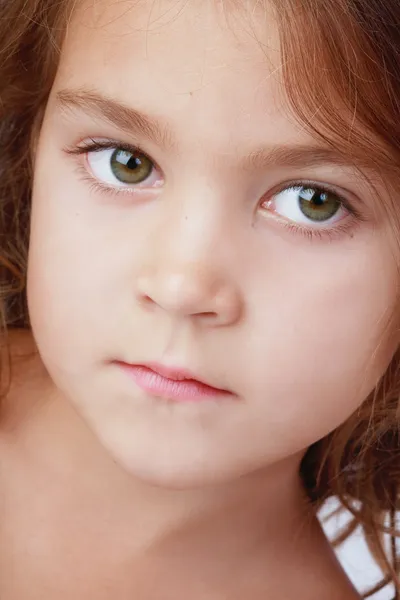 Close-up portrait of little girl with green eyes — Stock Photo, Image