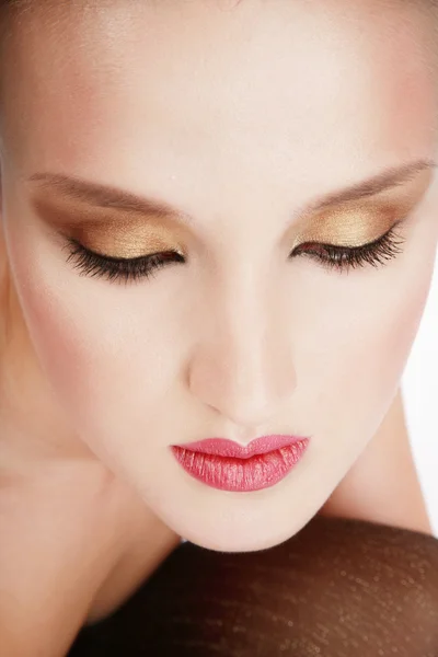 Close-up portrait of beautiful woman with professional makeup in golden colours — Stock Photo, Image