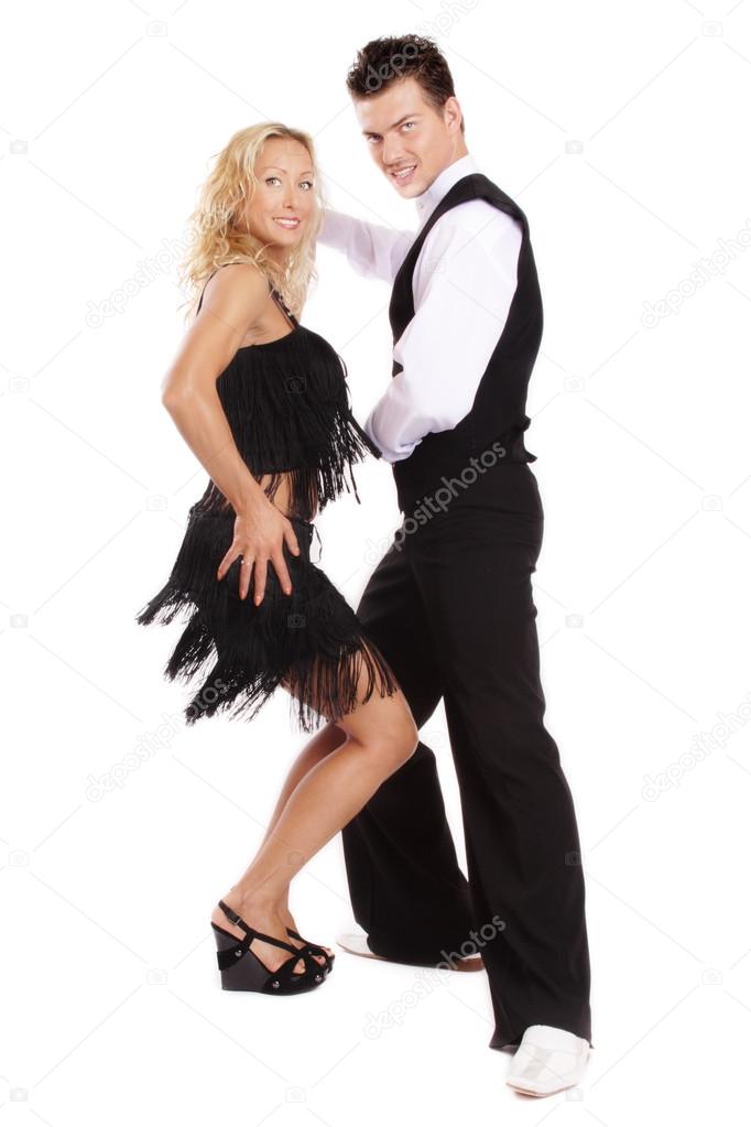 Beautiful blond and brunet dancing salsa on white background