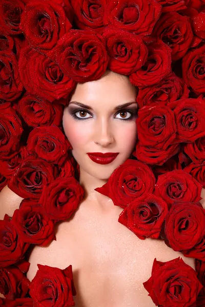 Girl in red roses — Stock Photo, Image