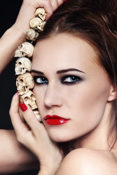 Woman with skull necklace — Stock Photo, Image