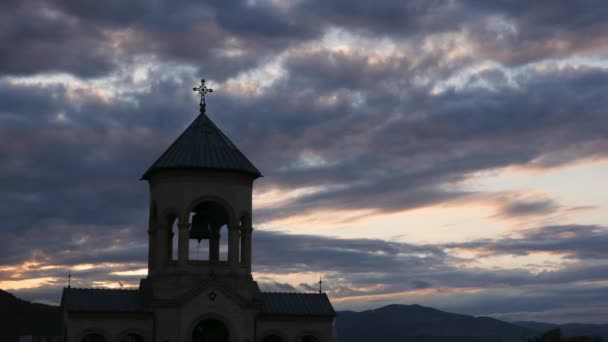Silhouette of bell tower in the rays of sunset. Time-lapse — Stock Video