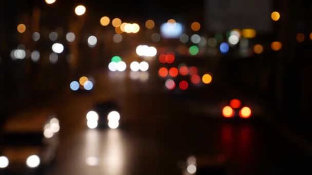 Beautiful glittering bokeh in dark blurry background at night. The round colorful bokeh shine from car lights on city street. Out of focus with blurry. Unfocused city lights. Traffic bokeh. Abstract — Stock Video