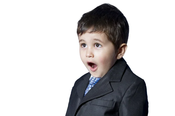 Překvapený podnikatel dítě v obleku s legrační obličej — Stock fotografie