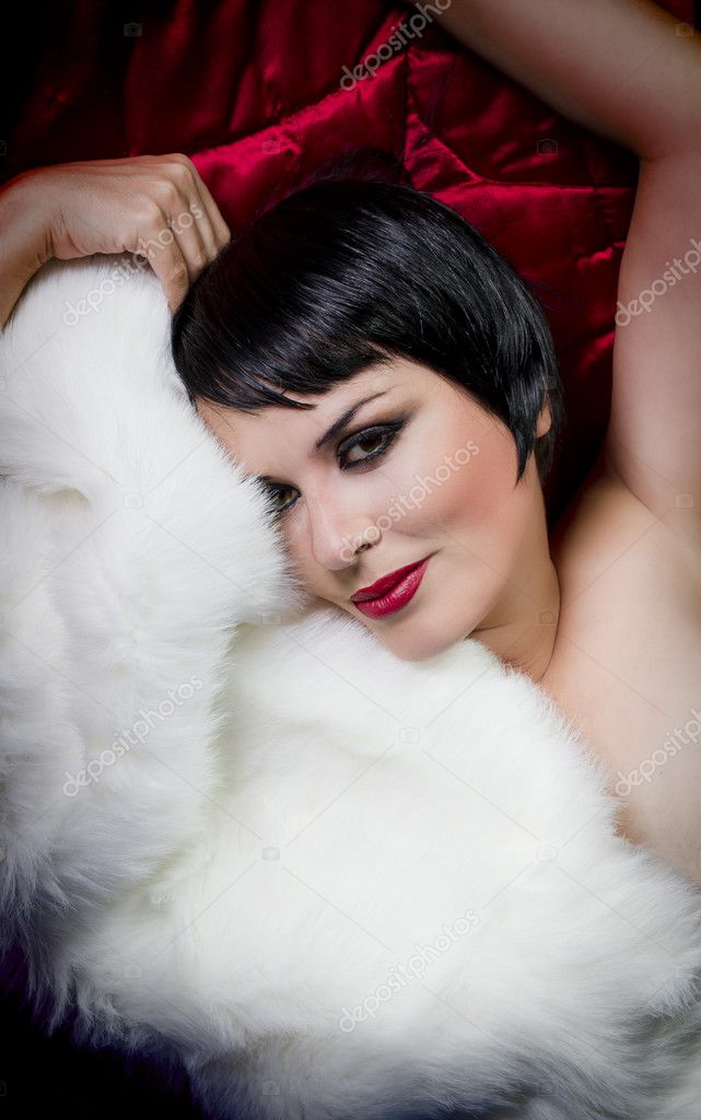 Seminude Beautiful Short Haired Brunette Woman Lying On Red Silk