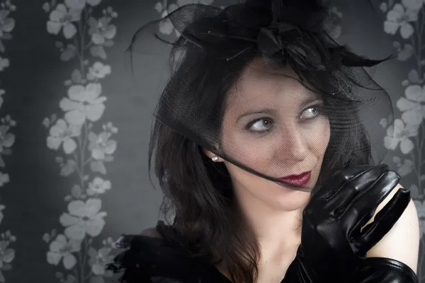 Portrait of young sexy woman in black veil on vintage wall — Stock Photo, Image