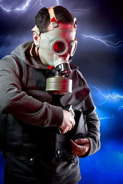 Homme avec une longue veste en cuir et fusil d'assaut sur backgr tempête — Photo