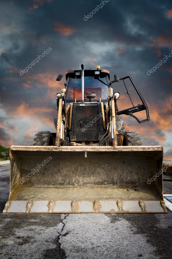 Bulldozer, Yellow tractor on dramatic sky background Stock Photo by  ©outsiderzone 18928977