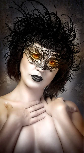 Young actress with venetian mask over fantasy background — Stock Photo, Image